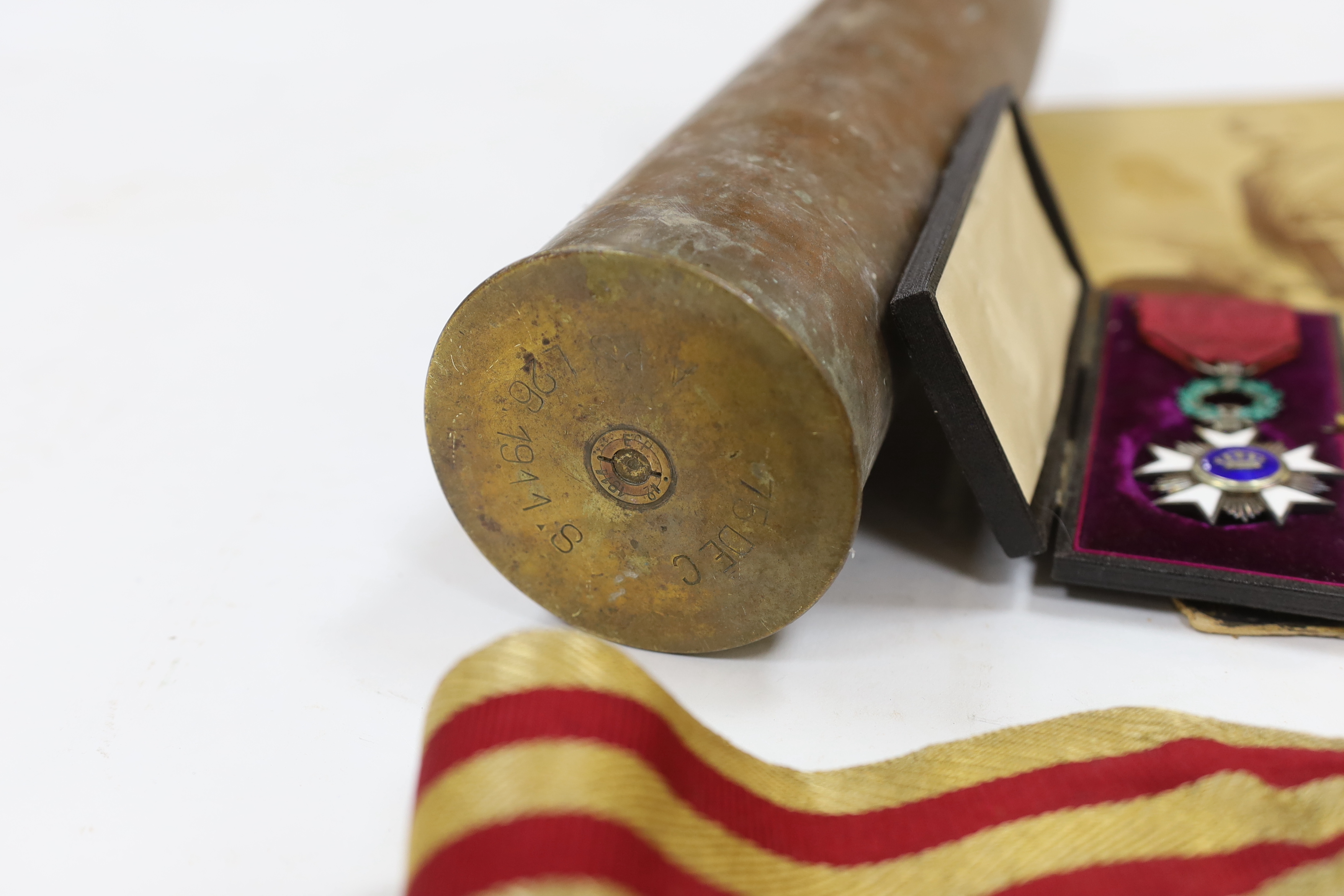 A late 19th century military sash with a related photograph showing the full uniform, a pair of Carl Zeiss binoculars, two compasses, a Belgium Order of the Crown cased medal, and a shell casing